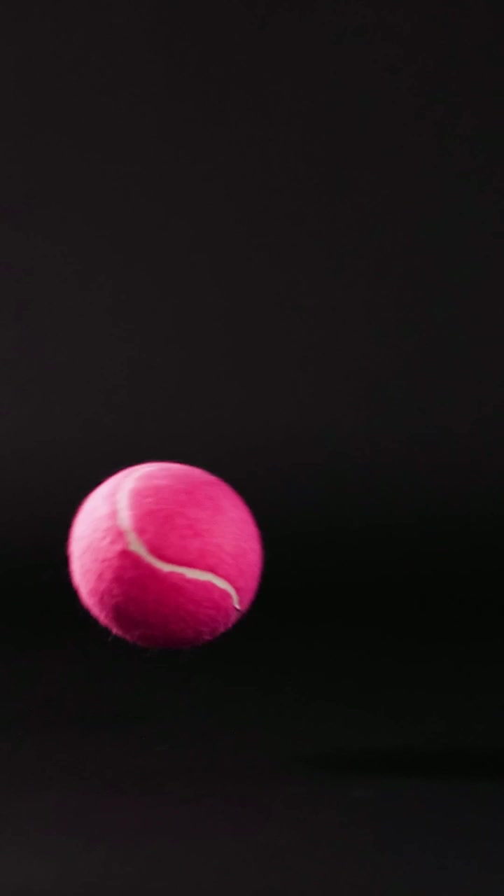 Pink ball bouncing on a dark background