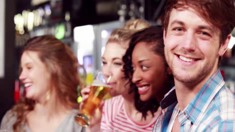 smiling friends having a drink together