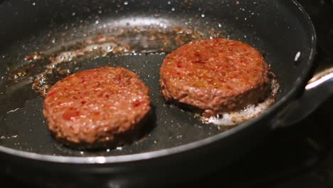 static medium shot of burgers cooking getting ready to serve in buns. beef patties food footage 4k.