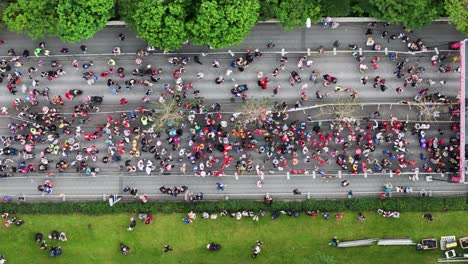 start line of marathon with people gathering on street during running event, top down