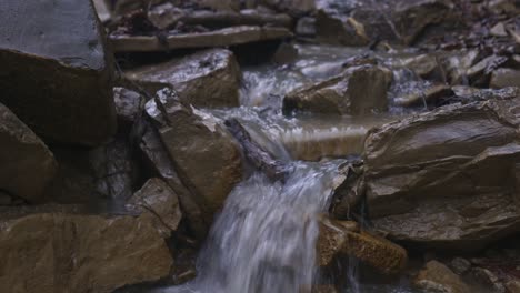 small clear waterfall cascade through rocks in nature, padure, latvia