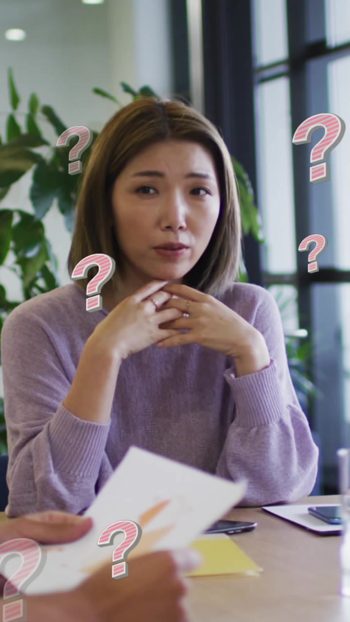 Animation of question marks over diverse business people having meeting at office