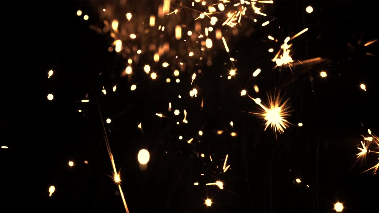 Scintille dorate luminose che cadono su sfondo nero