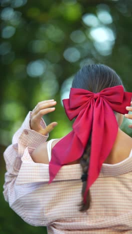 woman with red bow in hair