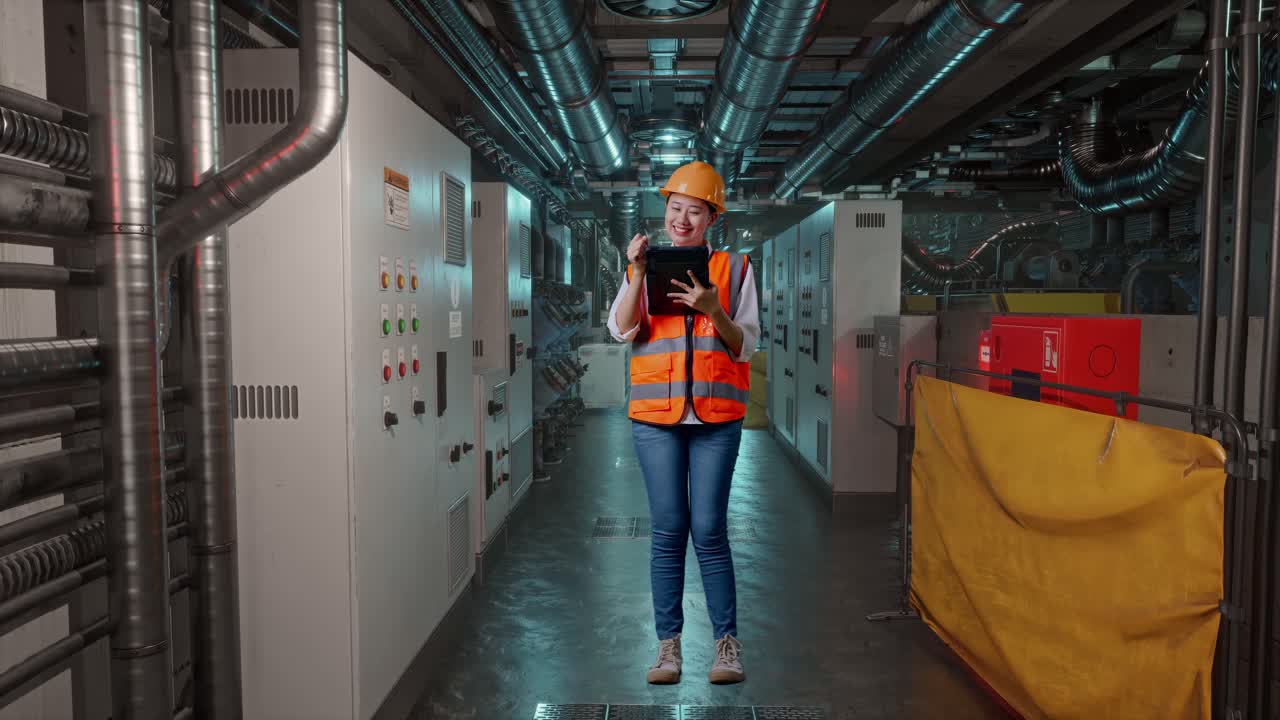 Female Engineer Working in Industrial Control Room