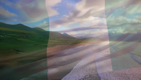 animation of flag of nigeria waving over beach landscape, sea and cloudy blue sky