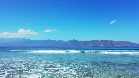 flat foamy waves rolling over the coral reef