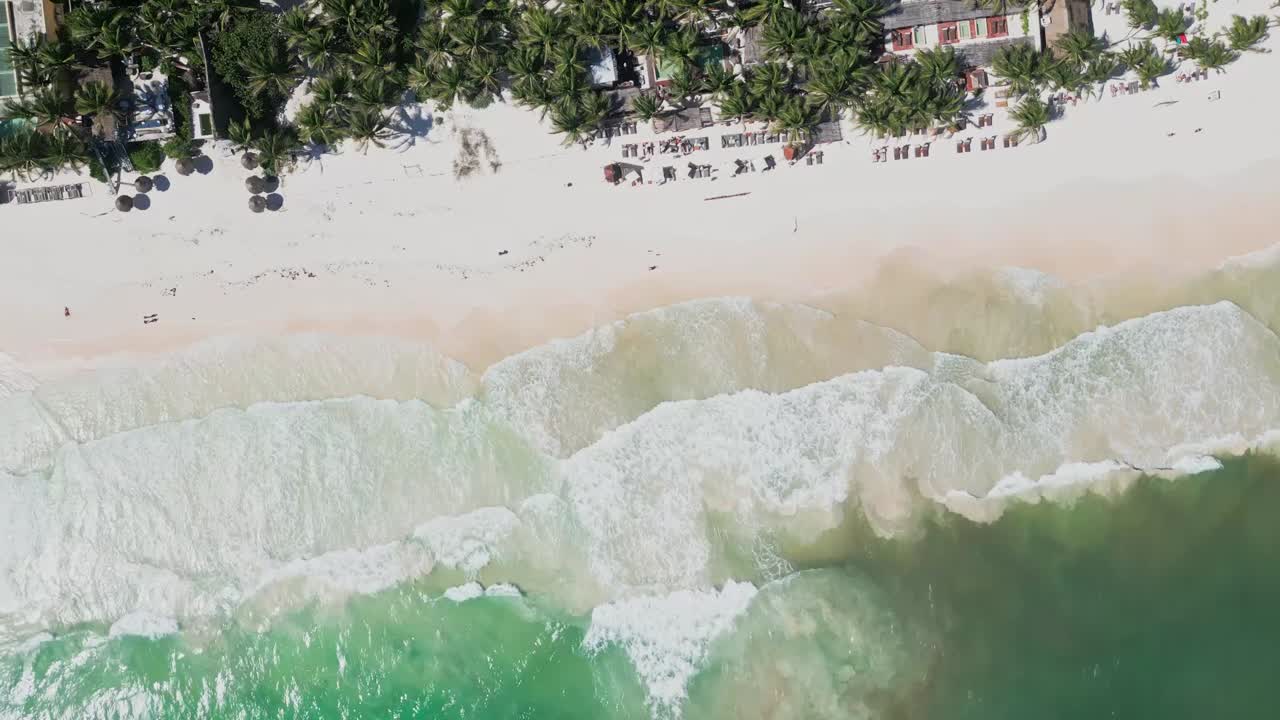 Aerial view of Tulum beach, waves crashing. Rotating camera, tropical vibe