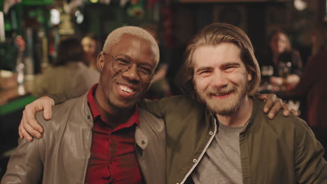 cheerful multi-ethnic mates at bar