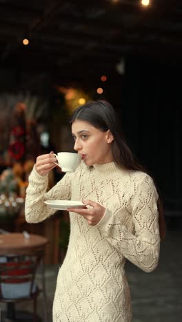 woman enjoying a warm drink in a cozy cafe