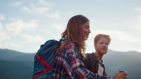 closeup happy hikers walk summer mountains. smiling couple backpack in nature