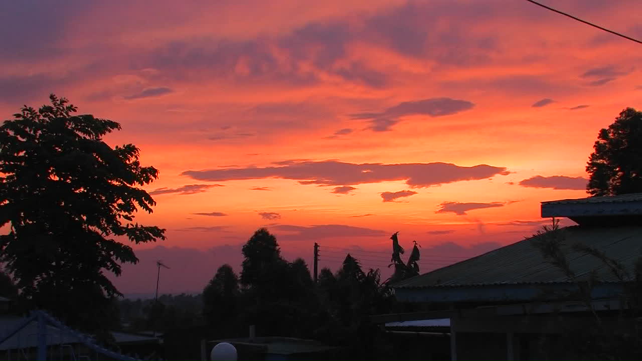 해가 아프리카 마을 위로 지고 있다