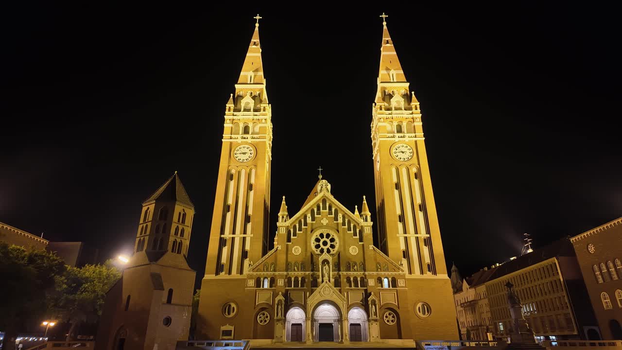 Front facade of the Szeged Cathedral and its twin towers at night in Hungary