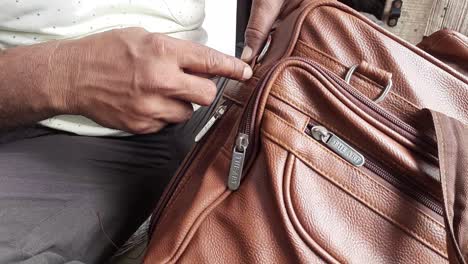 A-Man-Stitching,-Fix-or-Repair-Brown-Leather-Bag-O-Ring-By-Hand-In-India---Shoulder-Strap-O-Ring