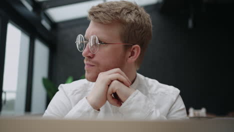 serious-businessman-is-reading-news-in-internet-and-analysing-data-in-report-and-thinking-about-developing