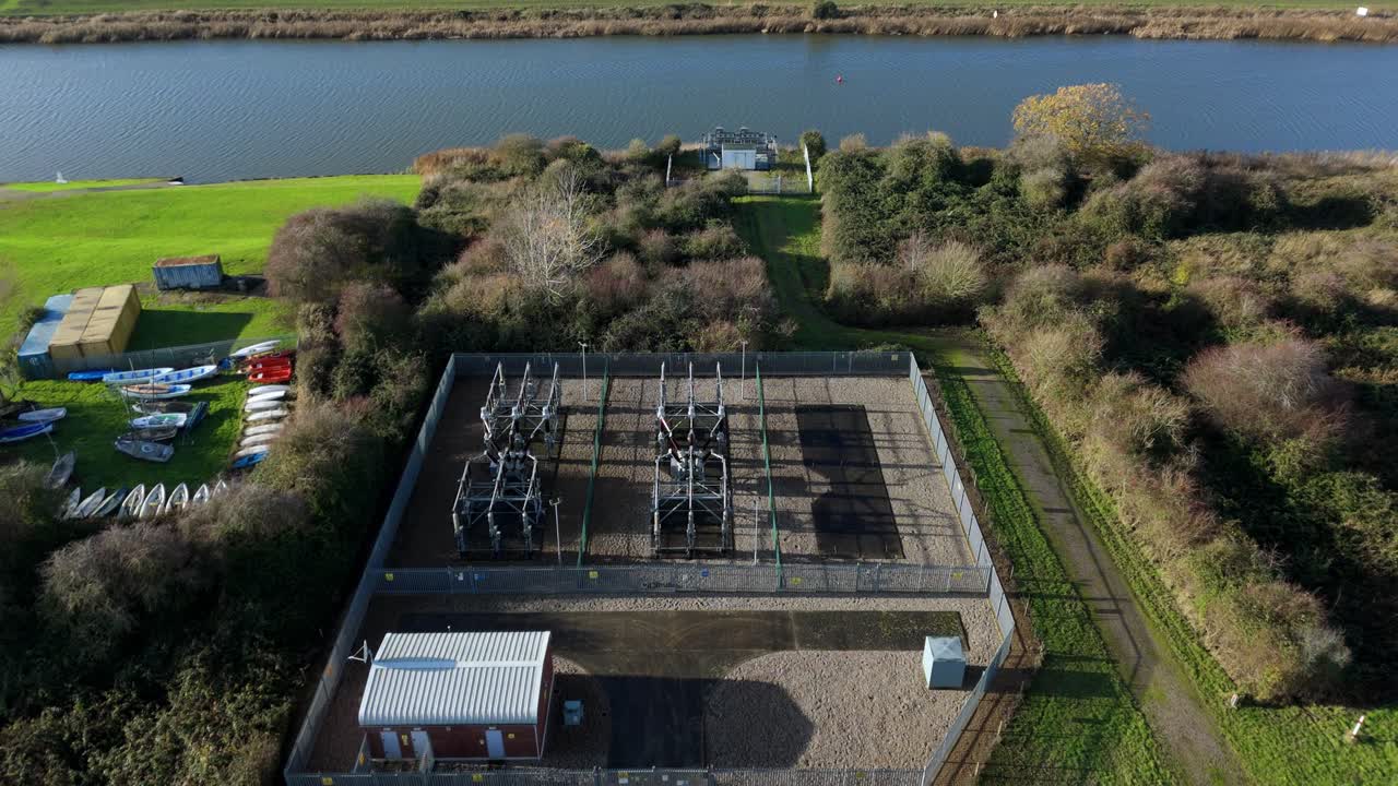 Aerial drone view of a small electrical substation situated on the banks of the River Great Ouse near King's Lynn, Norfolk, UK