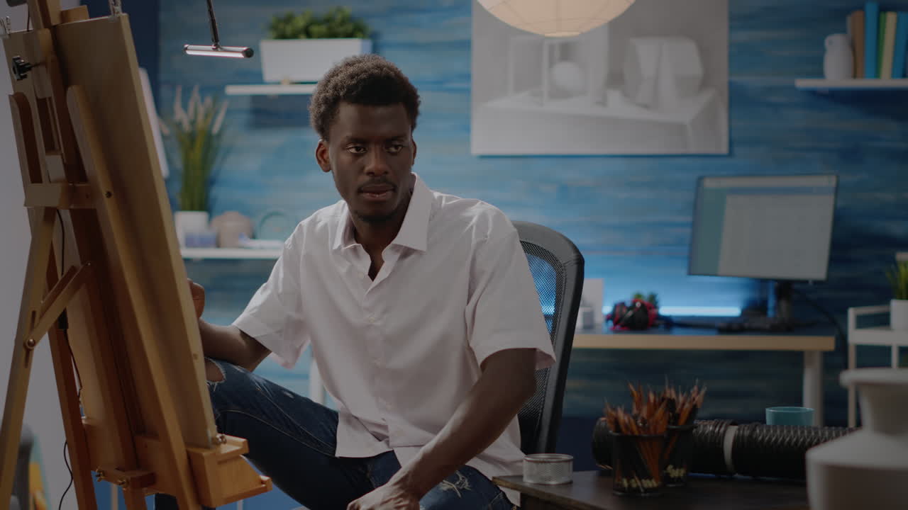 Artist of african american ethnicity working on drawing of vase