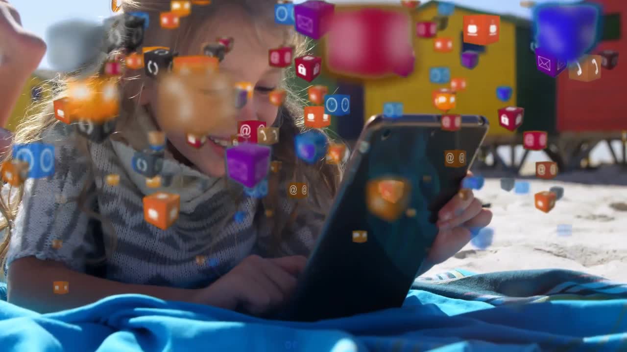 iconos digitales flotando contra la niña usando una tableta digital en la playa