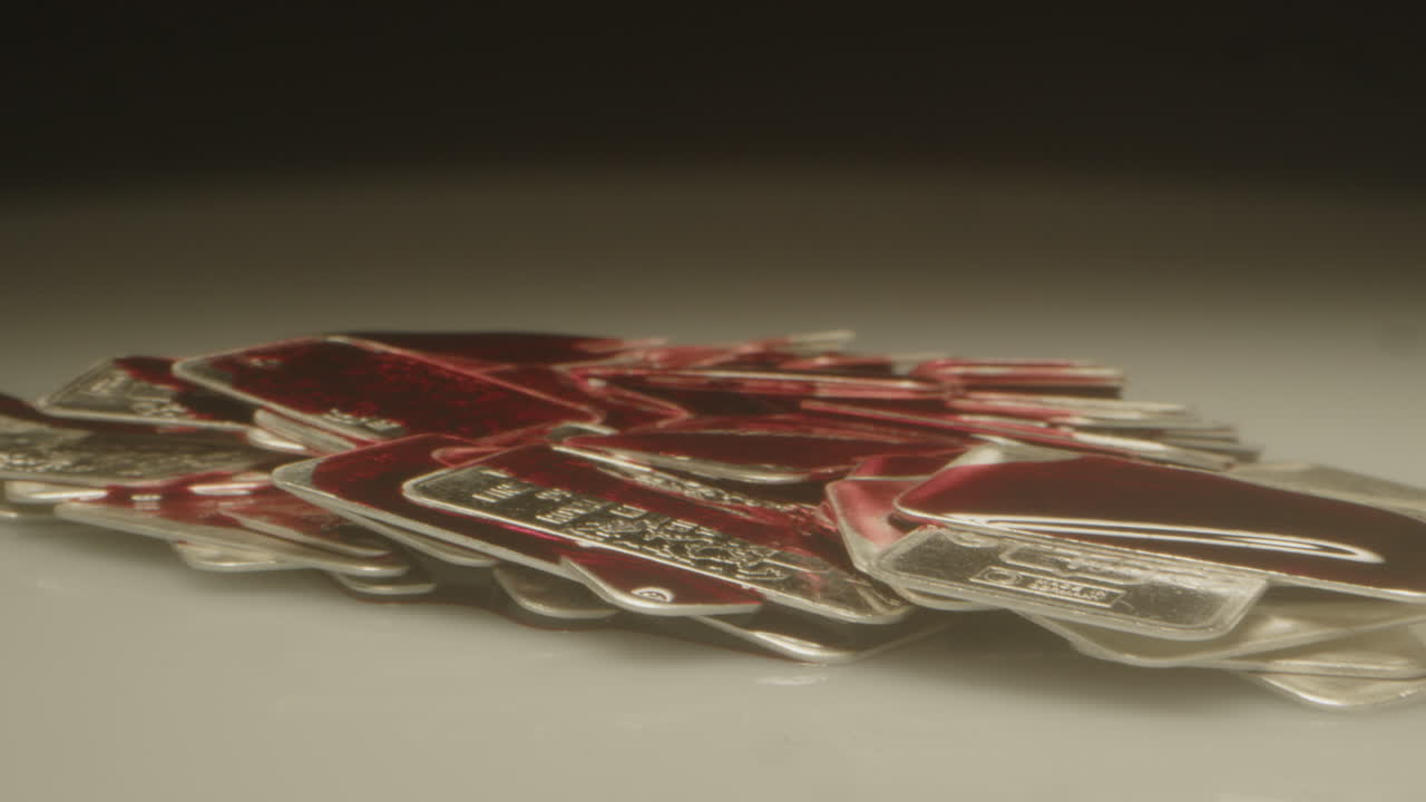 Stunning macro dolly out of a pile of silver bars covered in blood