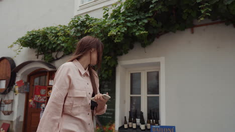 young woman walking through a european town