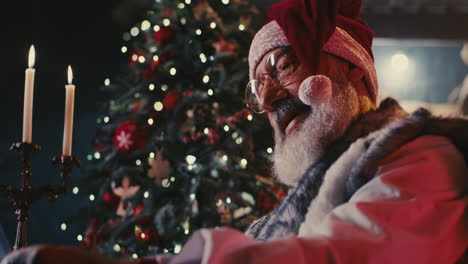 santa reading a letter by candlelight