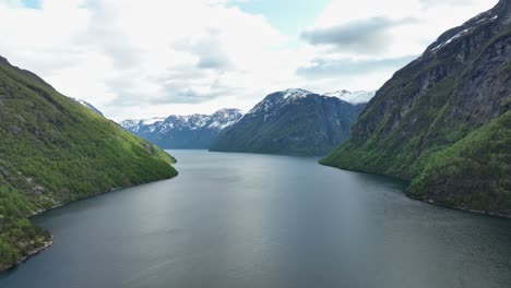 sunnylvsfjorden ahead with korsfjoden and geirangerfjord ahead and to the right side - aerial above norwegian wild fjord