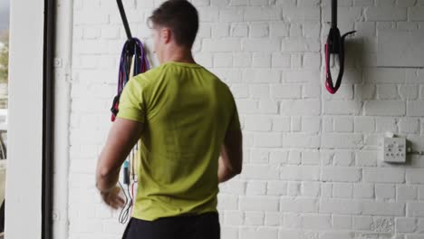 Rear-view-of-an-athletic-Caucasian-man-doing-chin-ups-on-a-bar