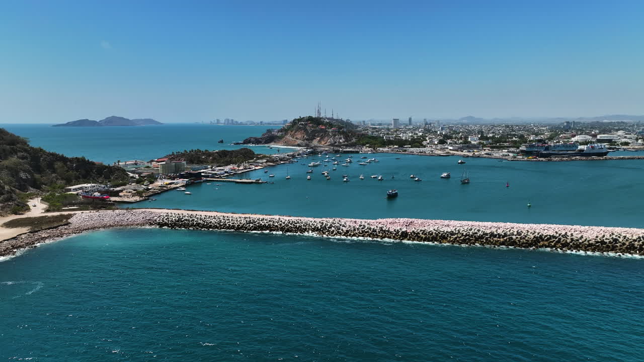 Aerial view rising away from a rocky pier at the Port of Mazatlan, in Mexico
