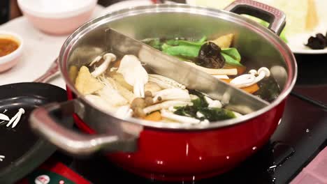 simmering hotpot with vegetables and mushrooms