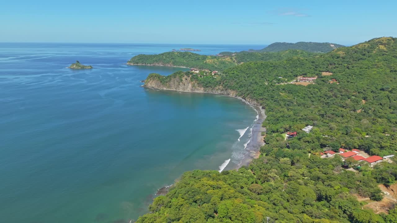 Zoom in aerial shot over Prieta Beach with turquoise waters and tropical hills in Costa Rica