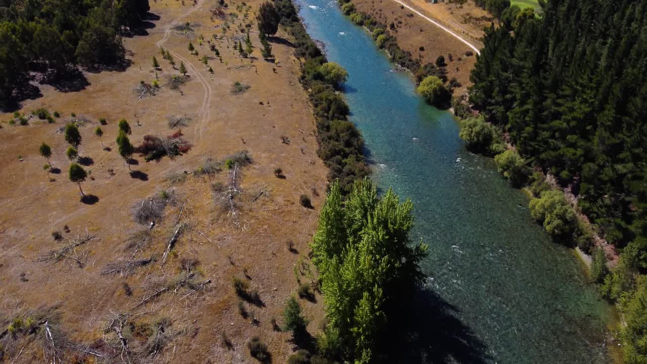 AERIAL Revealing Shot of a Stunning River Flowing through a Dry Otago Landscape in New Zealand