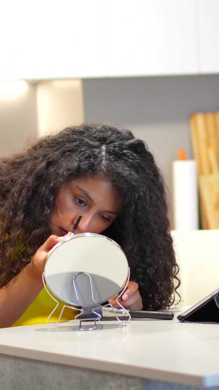 Woman Applying Makeup in Mirror at Home