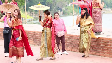 tourists exploring ayutthaya in traditional thai attire