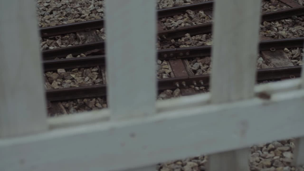 Mono rail miniature railway tracks through fence