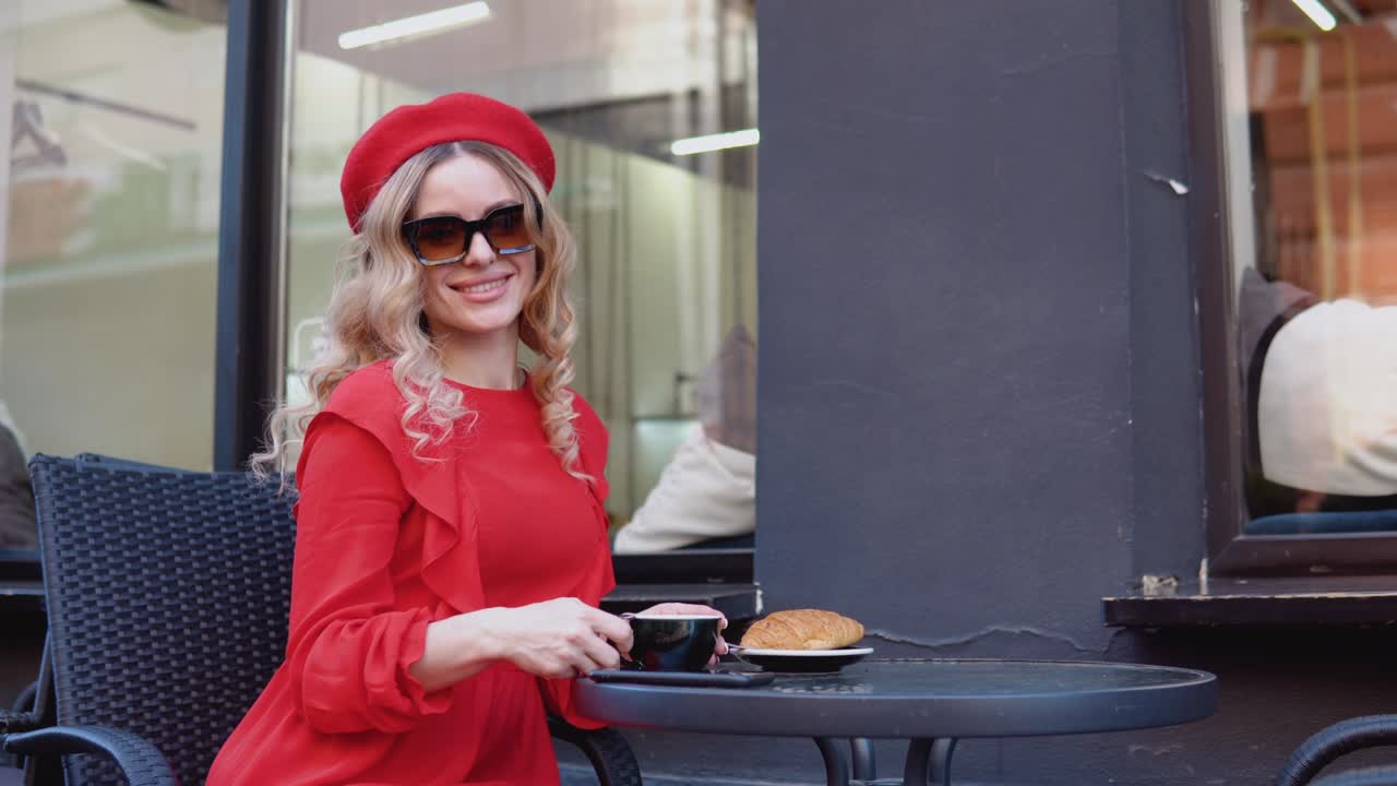 Coffee break with croissant. Lifestyle of a modern urban young woman