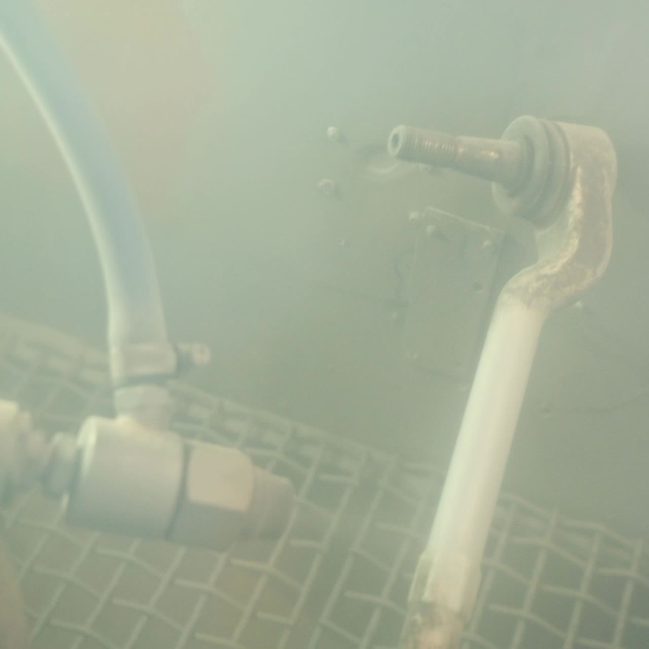 Hands of worker painting metal parts