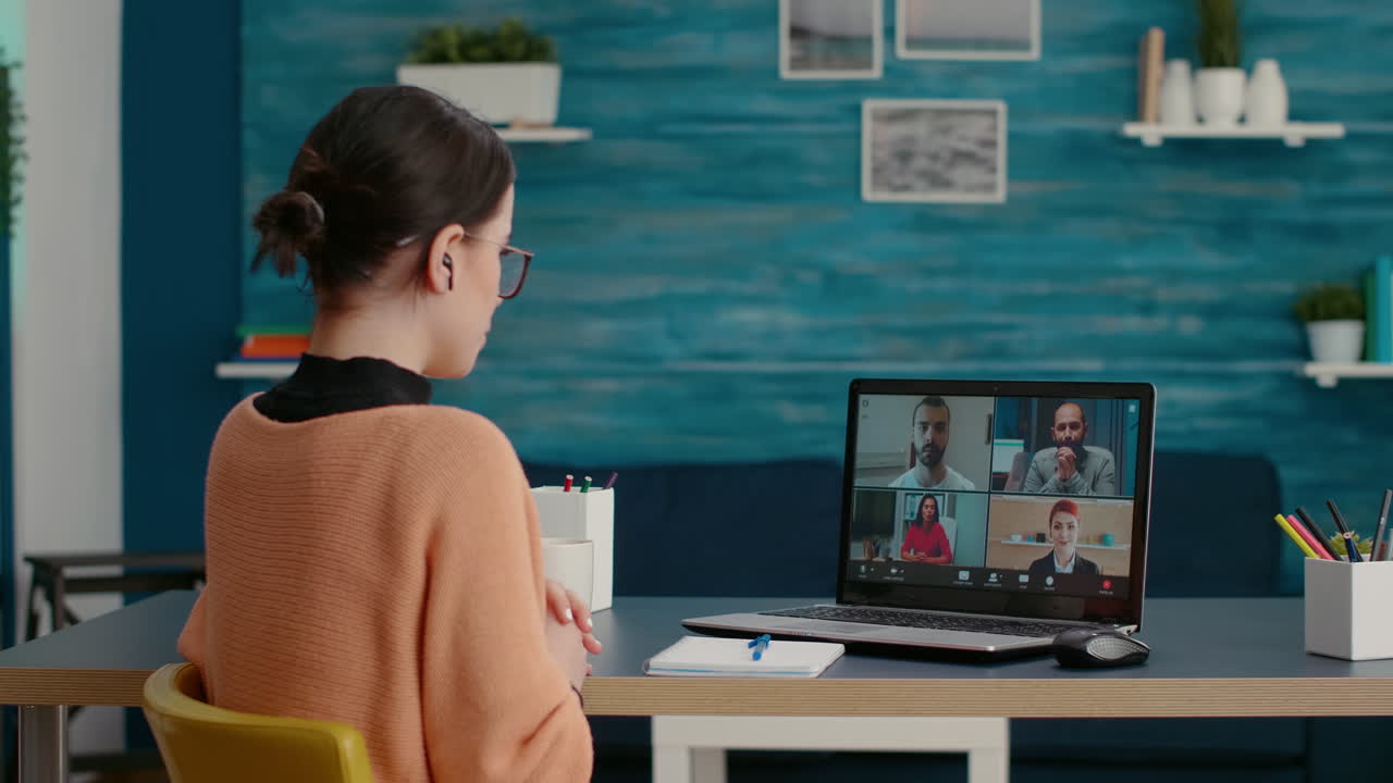 College student using laptop to attend remote videocall webinar