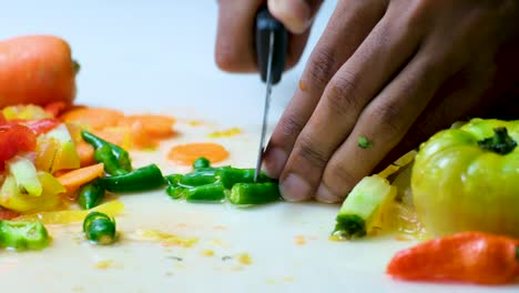 close-up of male hands cutting salad working in a restaurant