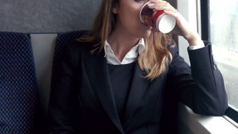 Businesswoman-using-phone-on-the-train