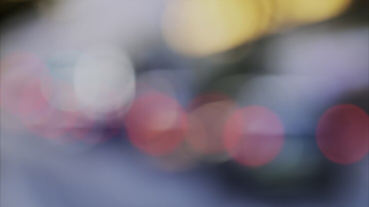 Out-of-focus blur of soft, circular light orbs moving around