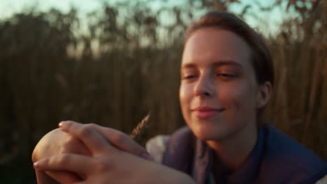 smiling woman wheat field portrait. farmer hands holding spikelet close up.