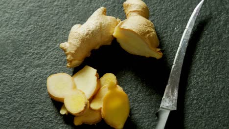 sliced ginger on black background 4k