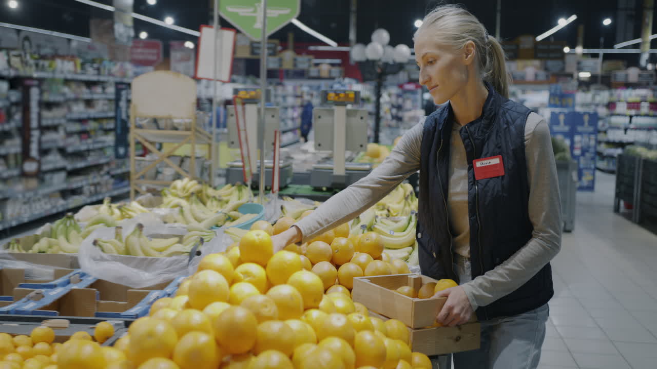 Woman working in a grocery store produce section