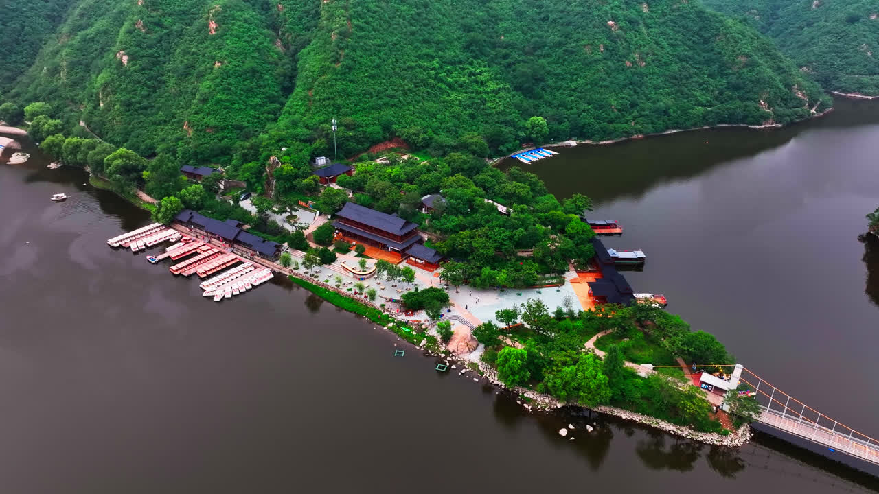 Aerial view orbiting the temple at the Huanghuacheng Great Wall, summer in China