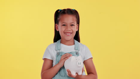 girl saving money in a piggy bank