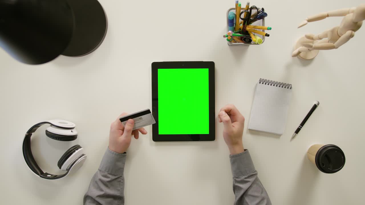A Finger Touching a Green Screen of the tablet computer