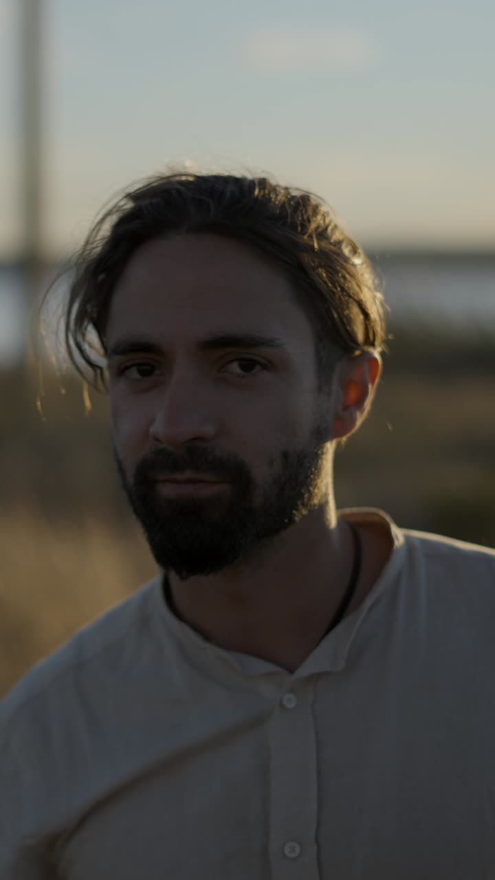 Man in white shirt outdoors at sunset