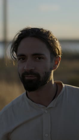 man in white shirt outdoors at sunset