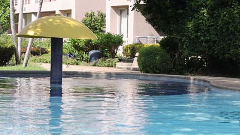 umbrella by a pool with changing water patterns