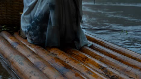 detailed closeup of barefoot feet of hanfu woman on bamboo raft by li river, china